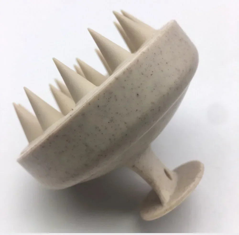 Beige scalp massager with spikes on a white background