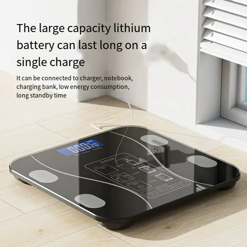 Digital bathroom scale on a wooden floor with text about battery capacity and features.